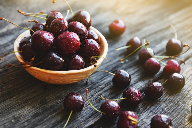 Cherries in a ceramic bowl on a wooden table