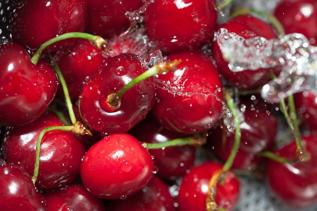 Cherries on a colander splashed by water