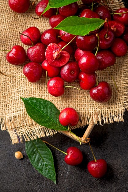 cherry on a black background A large abundance of cherries on a table against a black background closeup