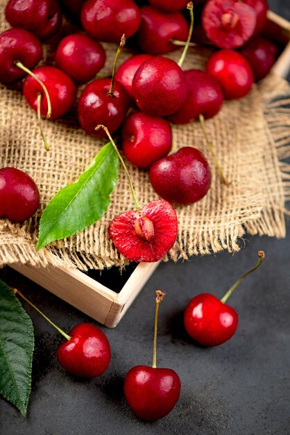 cherry on a black background A large abundance of cherries on a table against a black background closeup