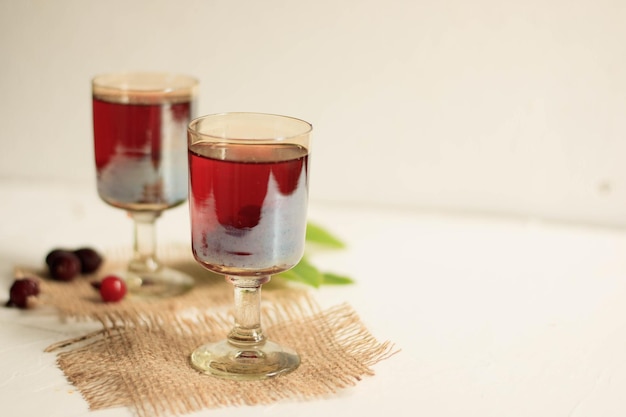 cherry brandy and ripe berries on wooden table