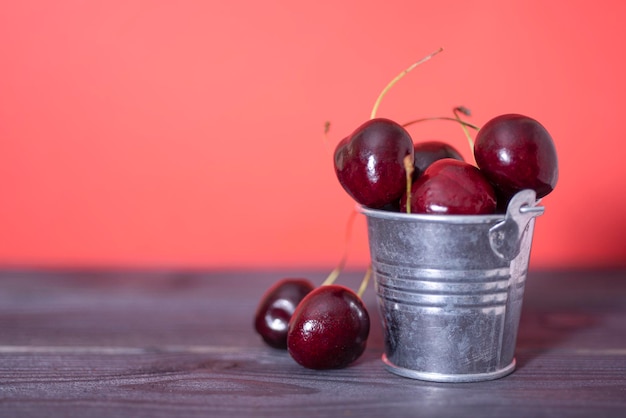 Cherry in a bucket on a dark and red background