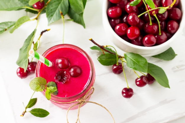 Cherry fruit Yogurt smoothie or milk shake in glass jar on a wooden table Natural detox