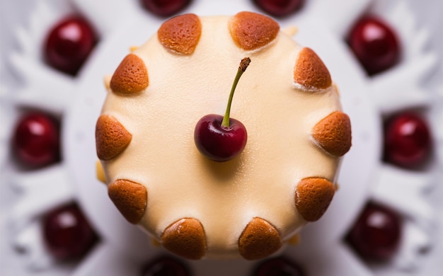 a cherry is being displayed on a cake with other cherries