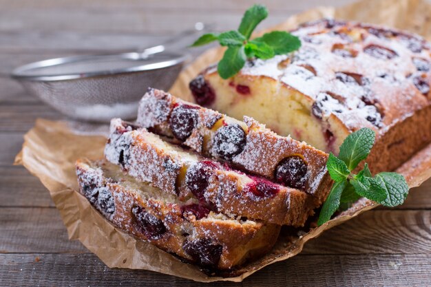 Cherry sponge cake with cherries powdered sugar and mint