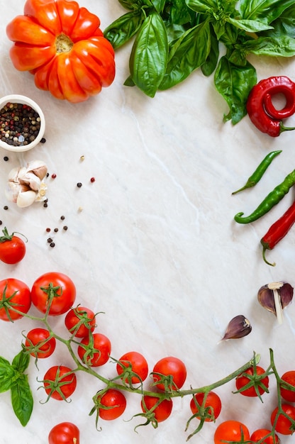 Cherry tomato branch garlic fresh basil pepper on a light background Ingredients for making sauces