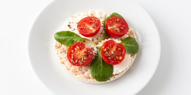 Cherry tomato fruit snack on rice cakes