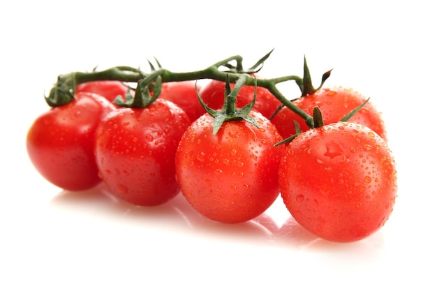 Cherry tomatoes on a branch with drops isolated on white