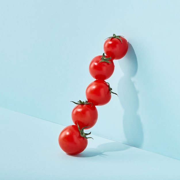 Cherry tomatoes on colored blue aqua wall