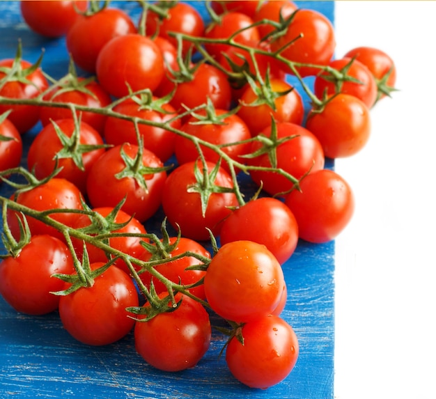 Cherry tomatoes on the old blue wood close up