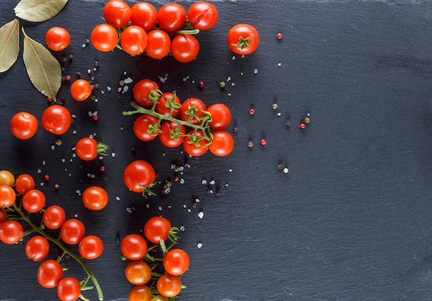 Cherry tomatoes on the twigs sprinkled with salt and pepper