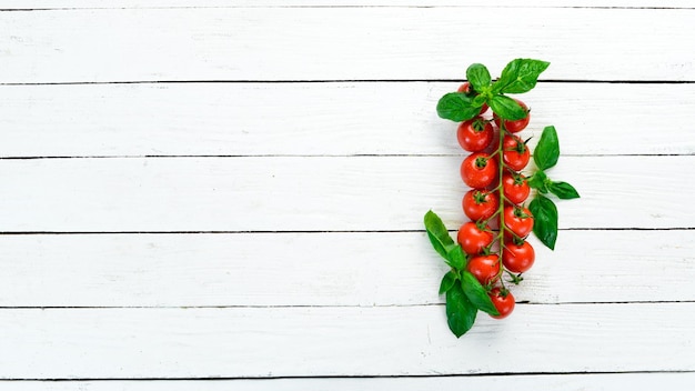 Cherry tomatoes on a white wooden background Top view Free space for your text