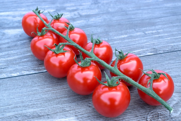 Cherry tomatoes on a wooden background.