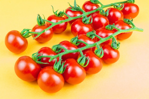 Cherry tomatoes on yellow 