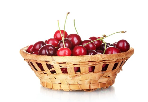 Cherry in wicker bowl isolated on white