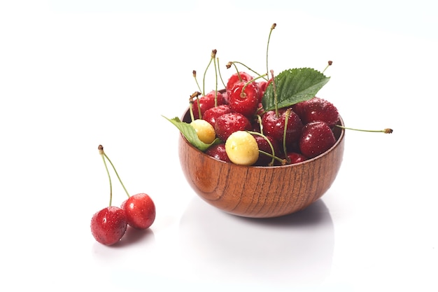 Cherry in wooden bowl isolated