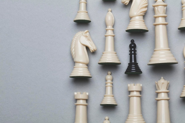 Chess game pieces on a grey background Strategy concept