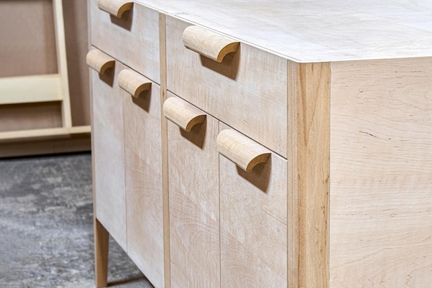 Chest of drawers made of solid alder in process of production at workshop close up view