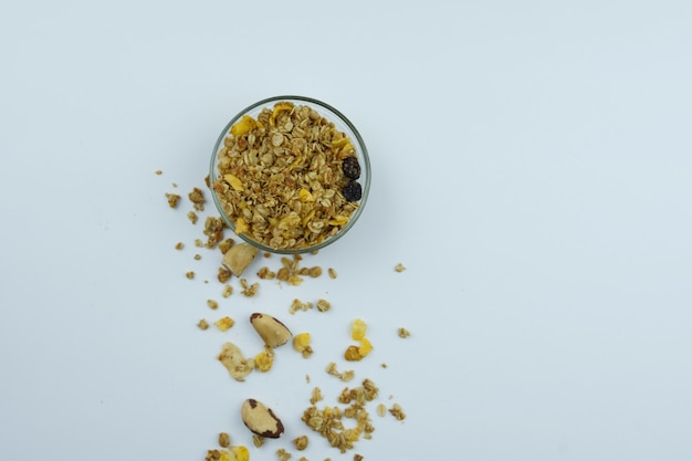 Chestnut and granola in a bowl. Top view on white background