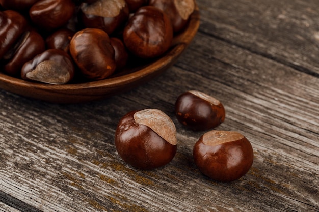 Chestnuts on an old wooden table.