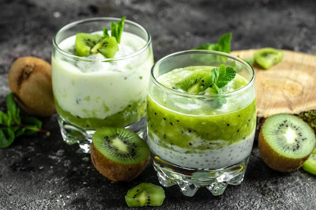 Chia pudding in a glass Healthy breakfast chia pudding with kiwi on dark background Long banner format top view