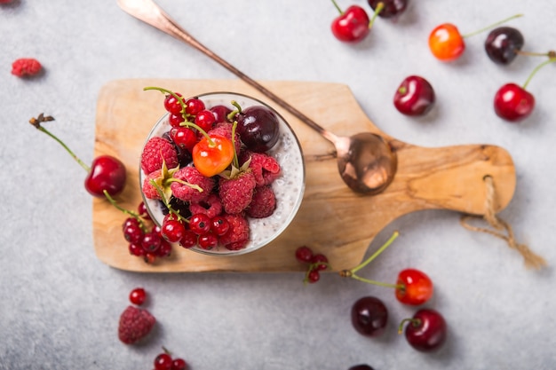 Chia pudding with cherry, raspberry, currant in glass bowl