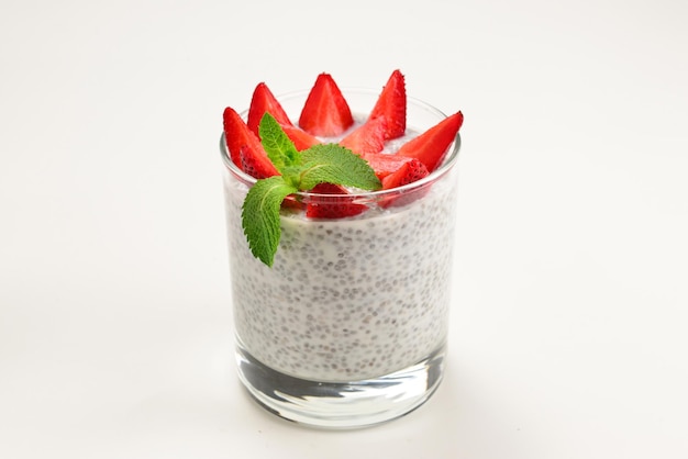 Chia pudding with strawberry and mint on a white background Space for text or design