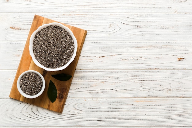 Chia seeds in bowl on colored background Healthy Salvia hispanica in small bowl Healthy superfood