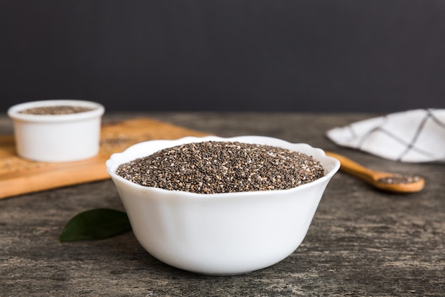 Chia seeds in bowl and spoon on colored background Healthy Salvia hispanica in small bowl Healthy superfood