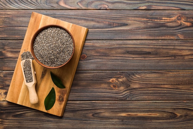 Chia seeds in bowl and spoon on colored background Healthy Salvia hispanica in small bowl Healthy superfood