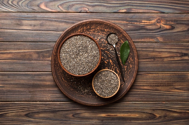 Chia seeds in bowl and spoon on colored background Healthy Salvia hispanica in small bowl Healthy superfood