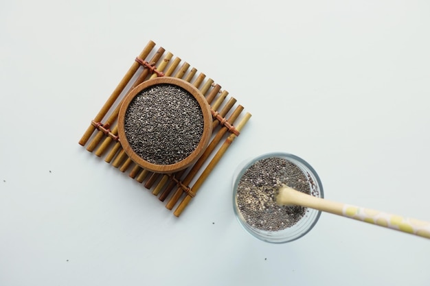 Chia seeds in wooden bowl superfood on a yellow background