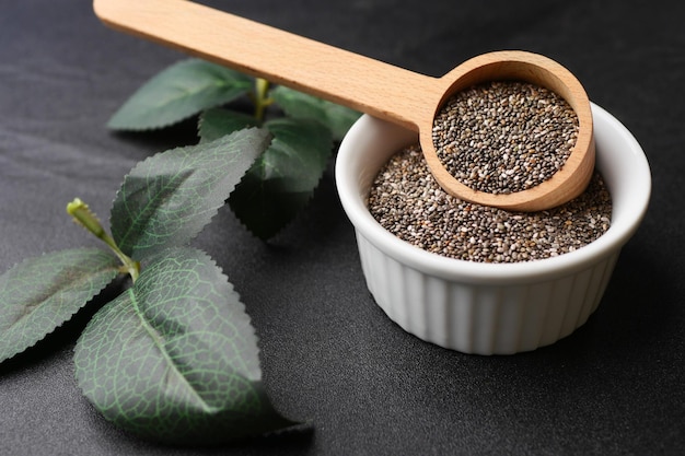 Chia seeds in wooden spoon and bowl