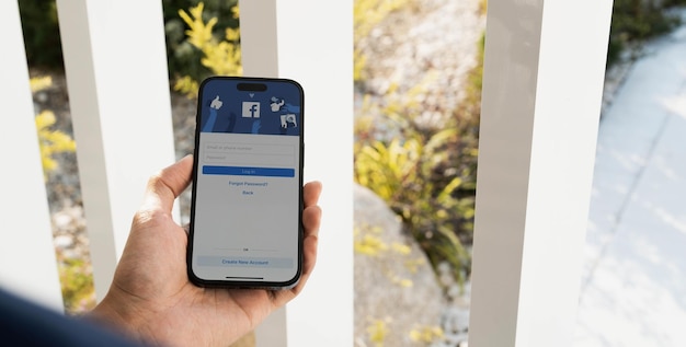 CHIANG MAI THAILAND FEB 11 2023 Facebook social media app logo on login signup registration page on mobile app screen on iPhone 14 in person's hand working on ecommerce shopping business