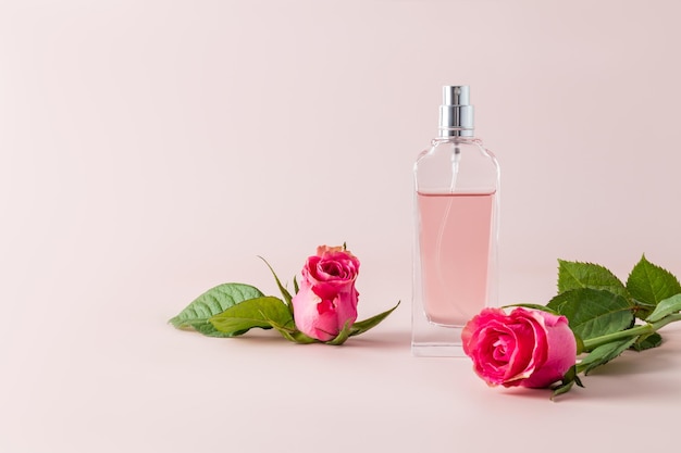 A chic bottle of womens perfume and a delicate flower tea rose with a rosebud Front view Unnamed bottle for product introduction