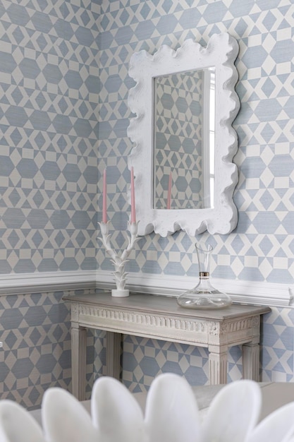 Chic Side Table and Organic Mirror Setup with Candles and Wallpaper