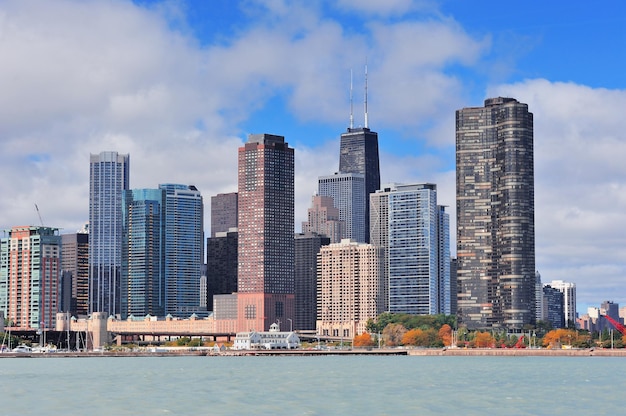 Chicago city urban skyline with skyscrapers over Lake Michigan with cloudy blue sky.