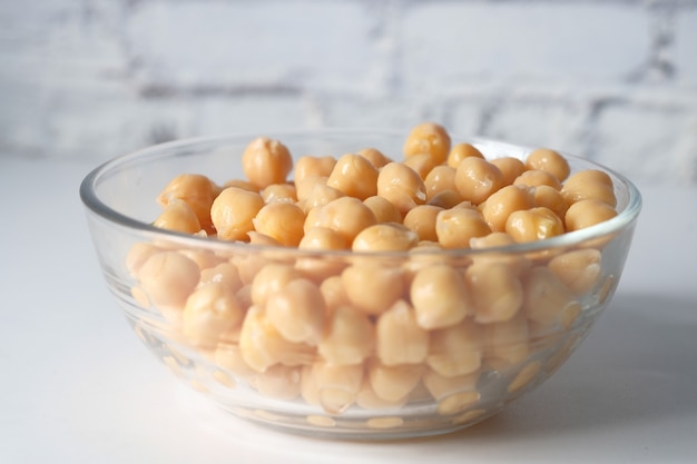 Chick peas in a bowl on white background .