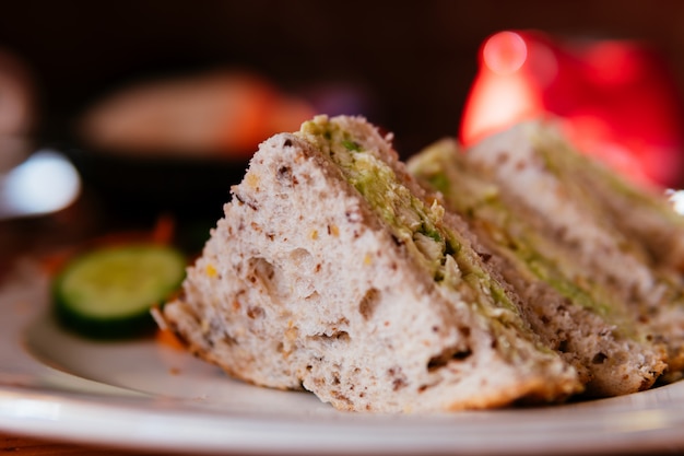 Chicken avocado sandwish in a plate.