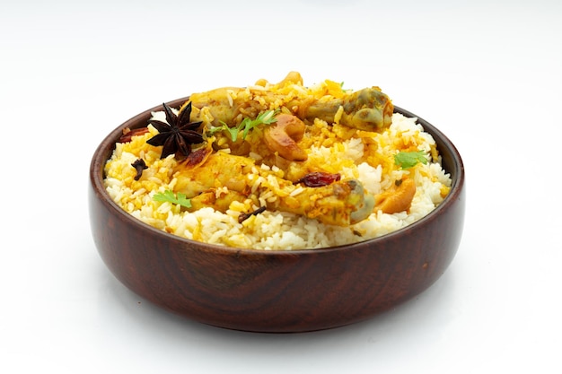 Chicken biryani made using jeera rice and spices arranged in a wooden tableware