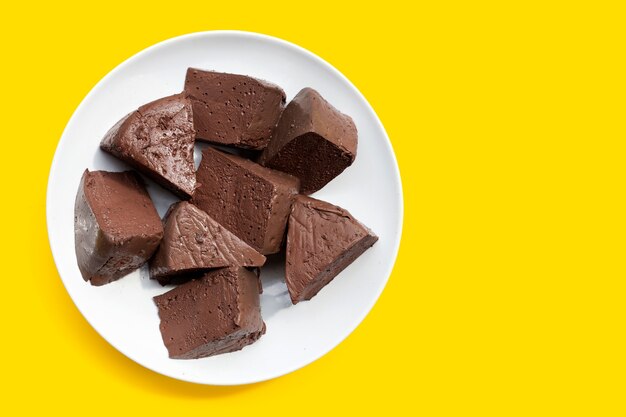 Chicken blood tofu in white plate on yellow background.