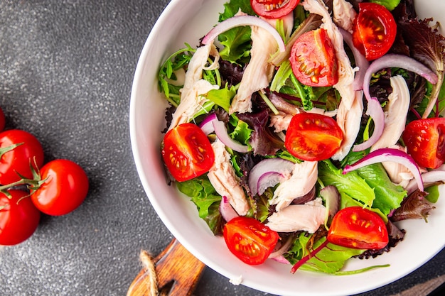 chicken breast salad tomato, green lettuce, onion healthy meal food snack on the table copy space