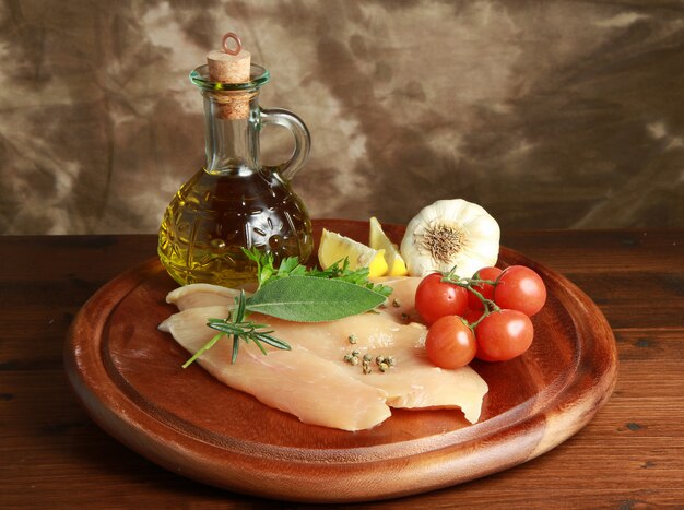 chicken breast on wooden board