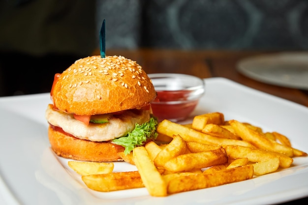 Chicken Burger and french fries on a white plate