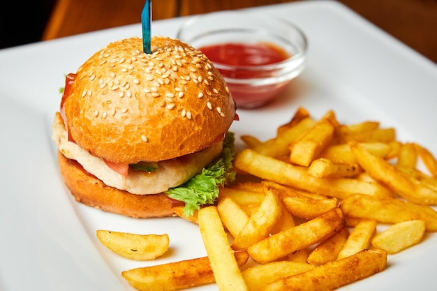 Chicken Burger and french fries on a white plate