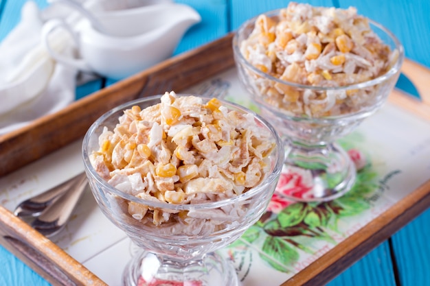 Chicken, corn, and egg salad in a glass bowl