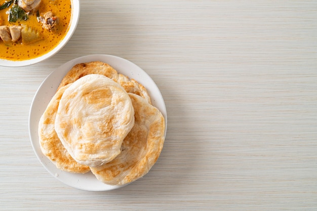 Chicken curry soup with roti