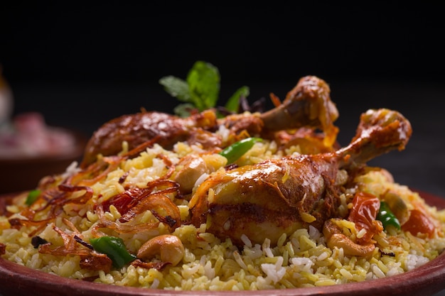 Chicken dhum biriyani using jeera rice and spices arranged in  earthen ware