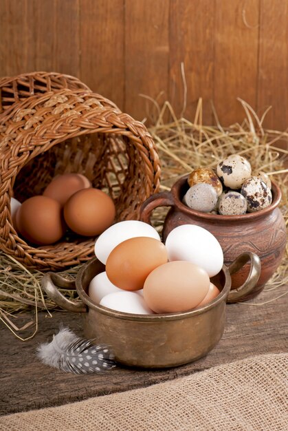 Chicken eggs in basket on wooden background