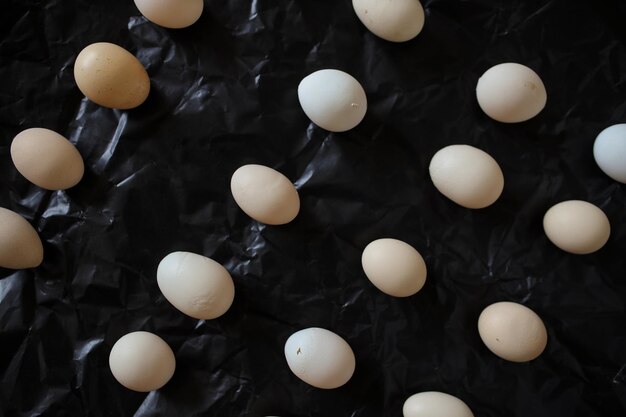 Chicken eggs on a black background Chicken eggs are symmetrical A few eggs on a black background